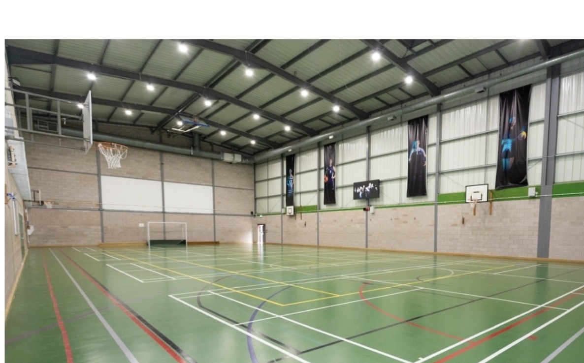 Epsom College Sports Hall 1, showing the actual green multi-use sports floor and badminton court markings